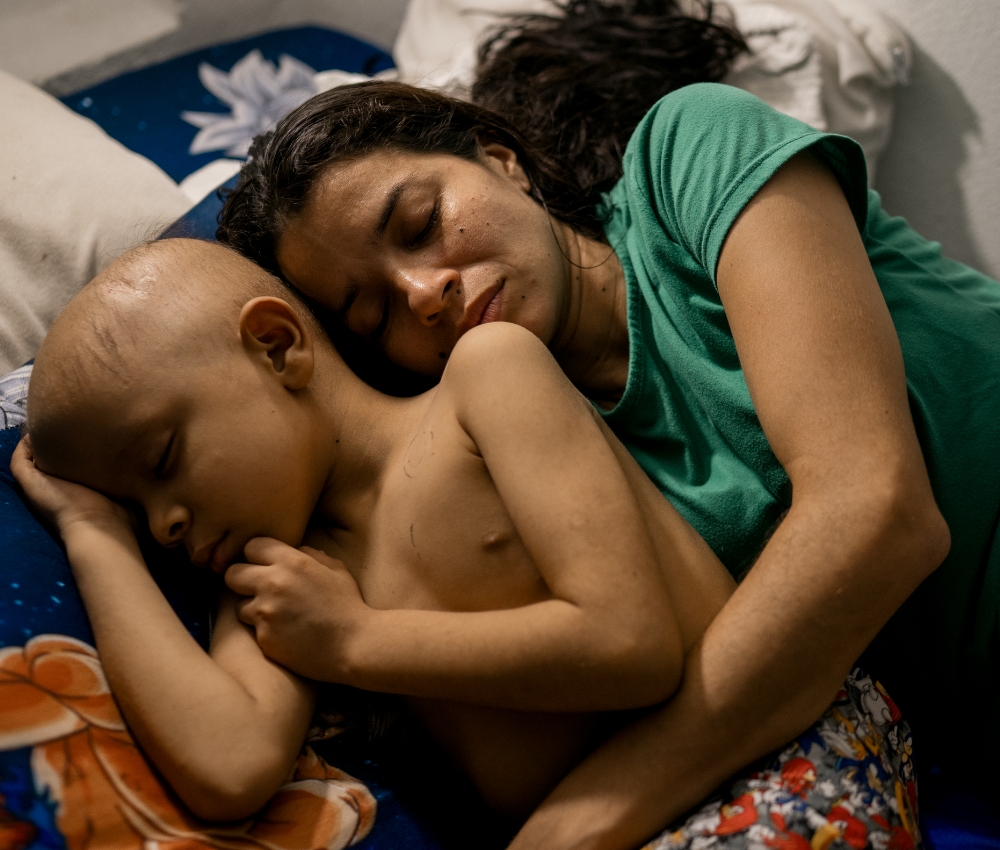 Mom and kid hugging in bed.