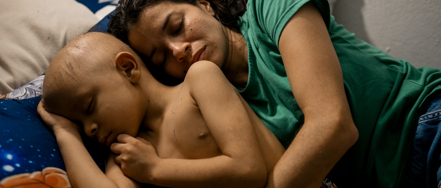 Mom and kid hugging in bed.