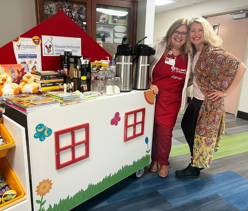 Volunteer and staff in the hospital with the Hospitality Cart.