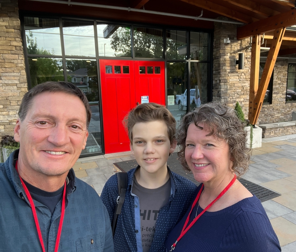 Family in front of the red doors at the House.